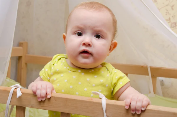 Surprised baby in a cot — Stock Photo, Image