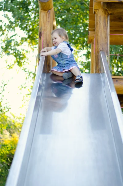 Little girl on the slide — Stock Photo, Image