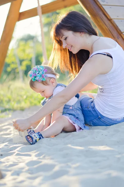 Mother and daughter on sand — Stock Photo, Image