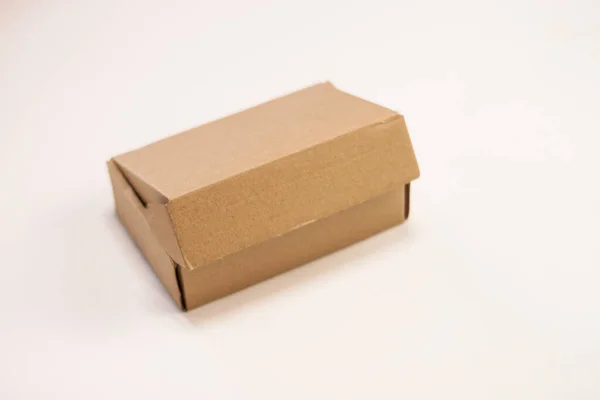 Small cardboard box for storing things on a white background. — Foto Stock