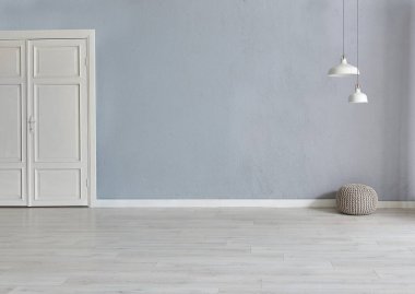 Grey stone wall background with white wooden door, lamp carpet and home style, poster decoration room interior.