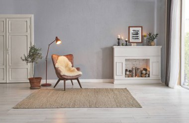 Modern room concept interior style, chair fireplace frame wicker carpet decoration, grey stone wall background.