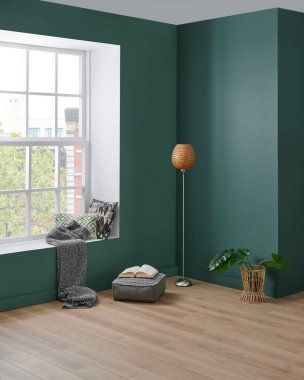 Modern köşe odası tarzı, yeşil duvar arka planı, sandalye konsepti, lamba battaniyesi ve yastık detayı..