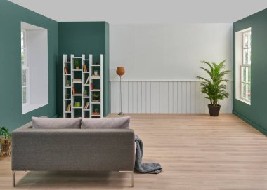 Dekoratif oturma odası, kanepe ve televizyon tarzı, yeşil ve beyaz duvar arka planı, kitaplık, dizüstü bilgisayarlı çalışma masası, bitki vazosu..