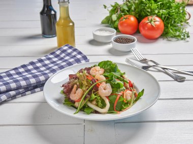 Green salad plate with shrimp for menu and vegetables background style.
