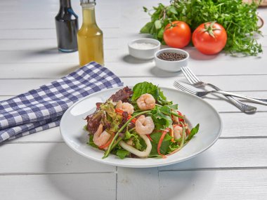 Green salad plate with shrimp for menu and vegetables background style.