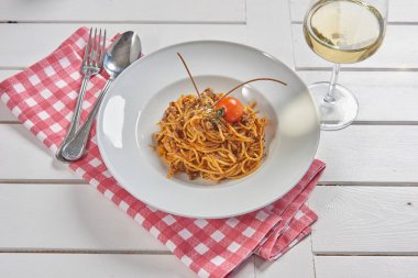 Pasta and macaroni in the plate for menu style with sauce background.