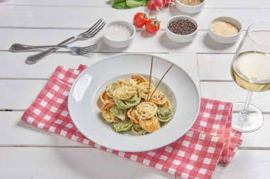 Pasta and macaroni in the plate for menu style with sauce background.
