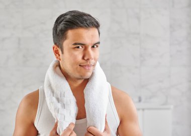 Man who wants to shave in front of the mirror, athlete and towel style, beard in the bathroom. Uzbekistan people.