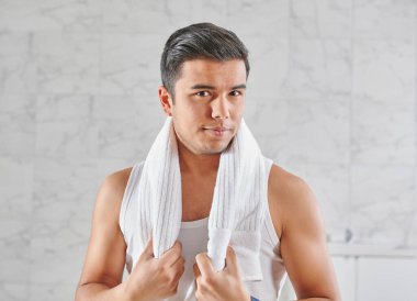 Man who wants to shave in front of the mirror, athlete and towel style, beard in the bathroom. Uzbekistan people.