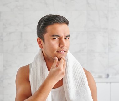 Man who wants to shave in front of the mirror, athlete and towel style, beard in the bathroom. Uzbekistan people.