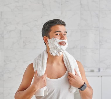 Man who wants to shave in front of the mirror, athlete and towel style, beard in the bathroom. Uzbekistan people.