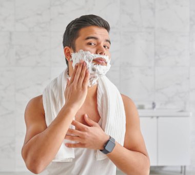 Man who wants to shave in front of the mirror, athlete and towel style, beard in the bathroom. Uzbekistan people.