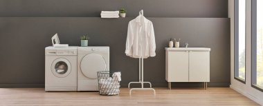 Gri duvardaki çamaşır ve kurutma makinesi arka plan, çamaşır, giysi, kanepe ve çalışma masası tarzı, minimalist iç mekan..