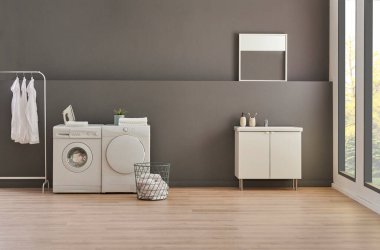 Gri duvardaki çamaşır ve kurutma makinesi arka plan, çamaşır, giysi, kanepe ve çalışma masası tarzı, minimalist iç mekan..