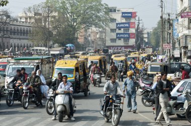 Traffic of people, cars and motorbikes in the street of New Delhi, India. one morning during my travel in india. a lot of people moving walking in the street everywhere. clipart