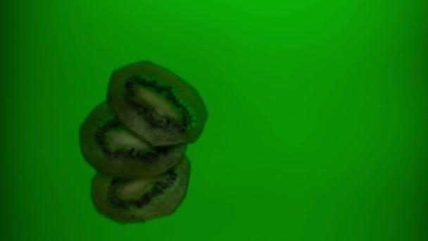 キウイはジュースに落ちます スローモーション240Fps 緑のジュース 新鮮な果物 — ストック動画