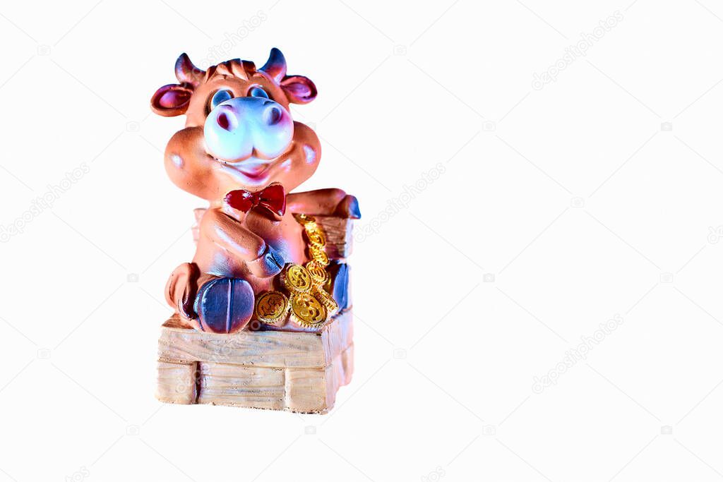 Toy cow sitting on a chair with gold coins money
