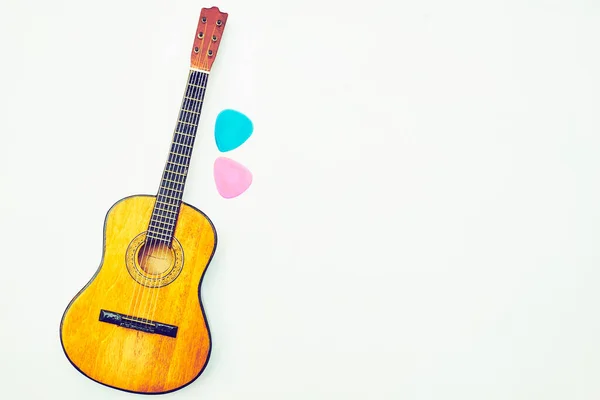 Wooden acoustic guitar two picks and space for text — Stock Photo, Image