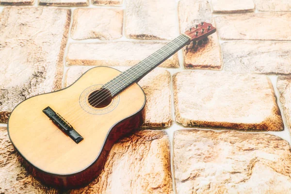 a brief record of facts, topics, or thoughts, written down as an aid to memory. a stringed musical instrument, with a fretted fingerboard, typically incurved sides, and six or twelve strings