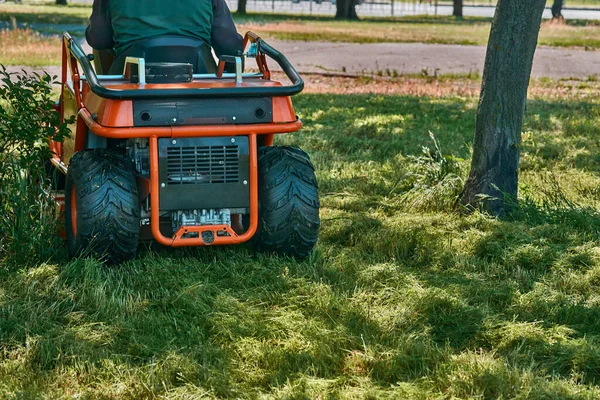 a machine for cutting the grass on a lawn. Professional grass cutting on lawns with a mini tractor lawn mower.