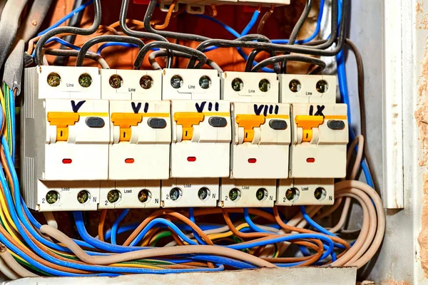 Junction box automatic machine in a new apartment. A box containing a junction of electric wires or cables close up.