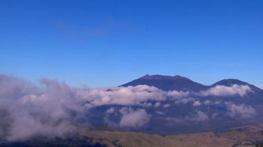View of Mount Raung seen from of Mount Ijen, Banyuwangi, East Java, Indonesia. The beautiful scenery of Mount Raung the clouds surround. 