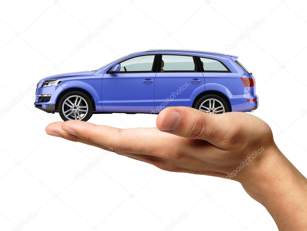Human hand with a car on the palm.