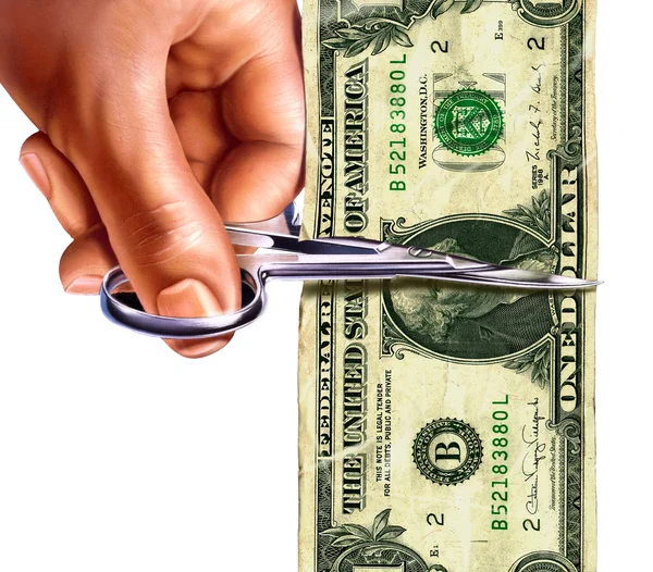 Uma nota de um dólar sendo cortada pela tesoura na mão — Fotografia de Stock