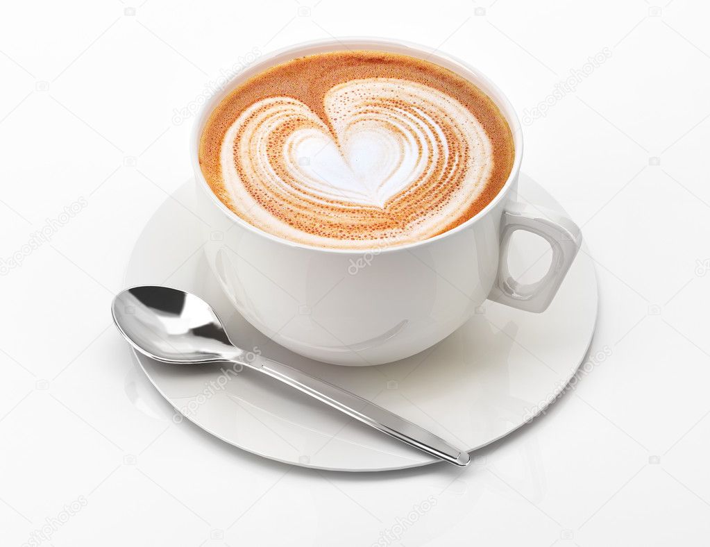 Cappuccino mug close up, with a heart decorated on top of foam.