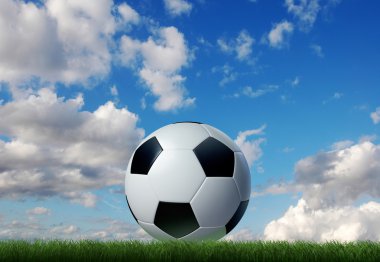 gökyüzü ve bulutlar arka plan üzerinde çim futbol topu.