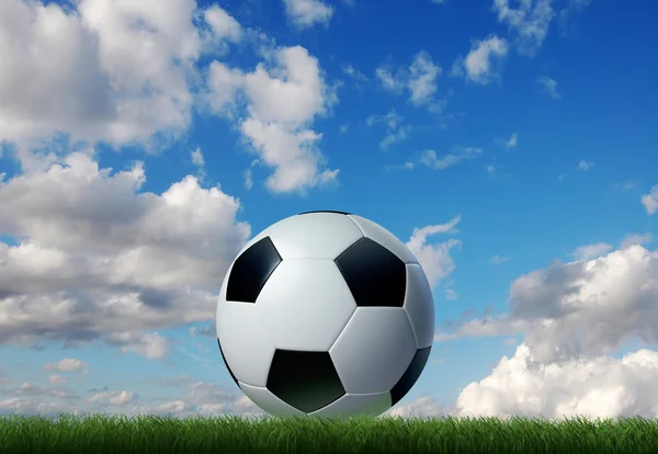 Soccer ball on grass with sky and clouds on background. — Stock Photo, Image