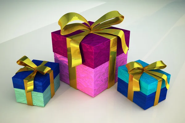 Three gifts with golden ribbons — Stock Photo, Image