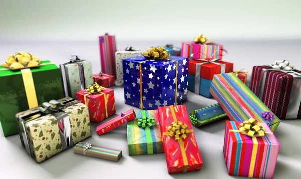 Group of gifts spread on a white surface, with one of them empha — Stock Photo, Image