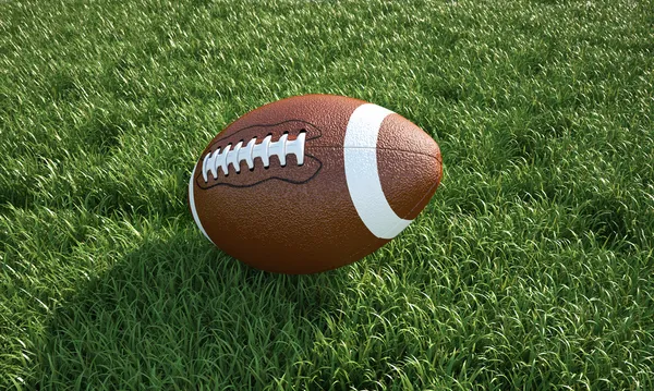 Ballon de football américain, sur l'herbe. Gros plan . — Photo