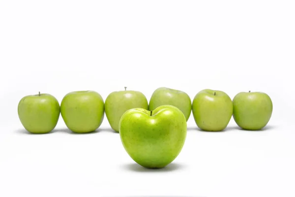 Sıraya Dizilmiş Diğer Yeşil Elmaların Önünde Duran Yeşil Elma Kalbi — Stok fotoğraf