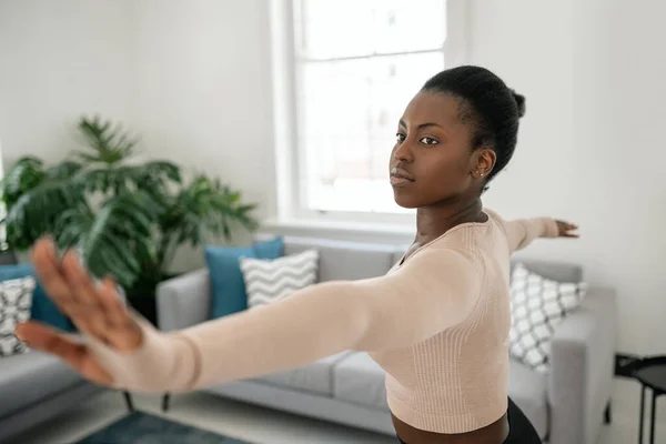 Close Young Black African Woman Stretching Warrior Yoga Pose Fitness Stockfoto