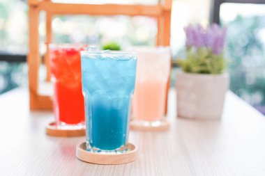 Buzda yaz için taze soğuk içecek. Sıcak bir gün ve parti için uzun bardakta, ahşap tabakla renkli bir yaz içkisi..