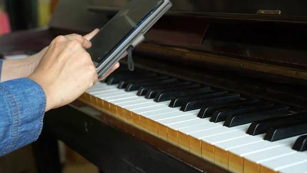 close up of a man playing piano