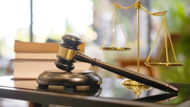 Lawyer or judge's hammer in the court. Auction's hammer is on woo table. Law subject or auction firm with book and golden judge's scale as symbol.