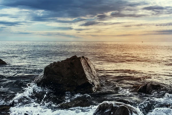 Large stone on a background of sea sunset — Stock Photo, Image