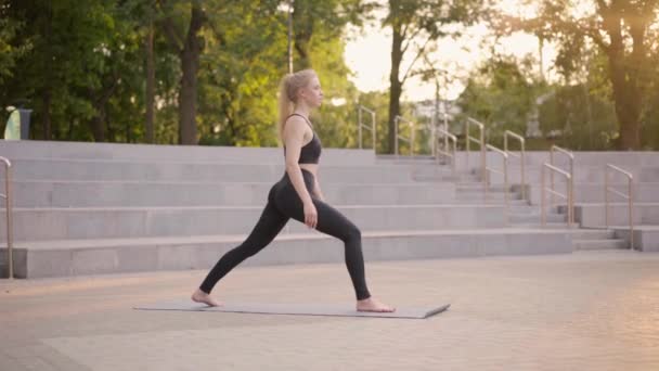 Fitness Woman Practice Yoga Exercises On Mat Outdoor City Street Sunlight Background — Stock Video