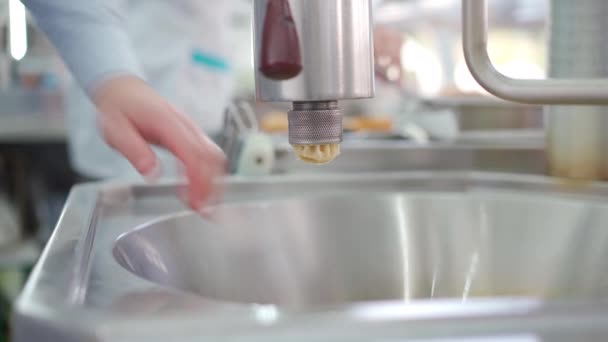 Fresh churro productions. Street food vendor prepares churros squeezing the dough into a machine. Spanish traditional donut. — Stock Video