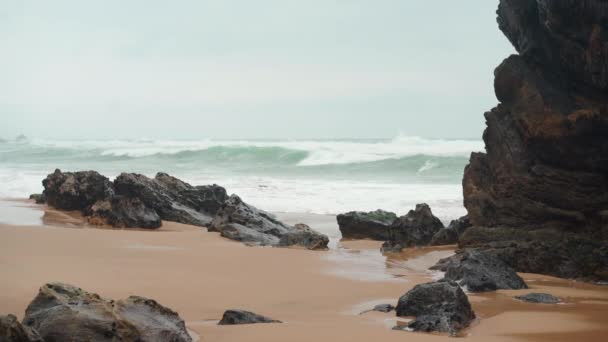 Ocean wild beach stormy weather. Praia da Adraga sandy beach with picturesque landscape background, Sintra Cascais, Portugal — ストック動画