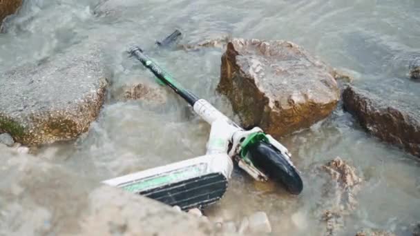 Portugal, Lisbon May 2022 Electrical Scooter Thrown in Water. Compact vehicle zero emission with the latest technology. bad behavior in disposing of used goods — Video