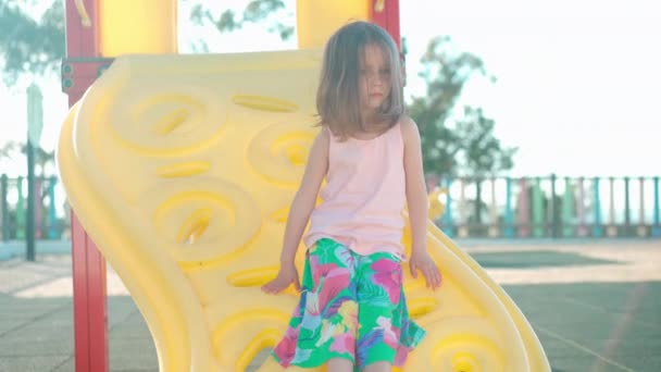 Child playing on playground warm summer day. Little girl have fun. Happy childhood. — Vídeo de Stock