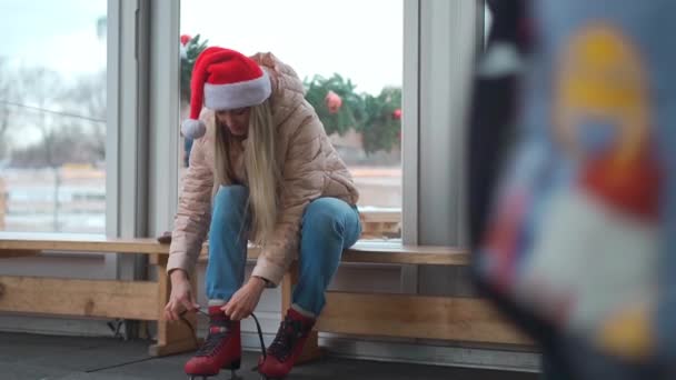 Wintertime Middle Age Woman Santa Hat Put Ice Skates Sitting — Vídeos de Stock