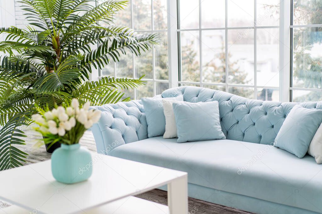 Luxury house interior. ELegant living room Modern Interior design. White Living Room Tulip flowers standing vase on coffee table