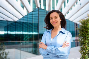 Businesswoman portrait. Caucasian female business person standing outdoor looking at camera close up face. Young beautiful modern business woman 30s years. Confidence employer smile. positive emotion