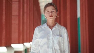 Sick tired exhausted displeased brunette young woman 30s years old wearing white shirt. Young businesswoman stressed overwork have migraine Put hands on head having headache. Slow motion portrait